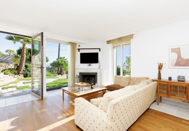 Villa 06LERI: Luxe living room with a sofa, flat screen, and garden view - Théoule-sur Mer, Côte d'Azur
