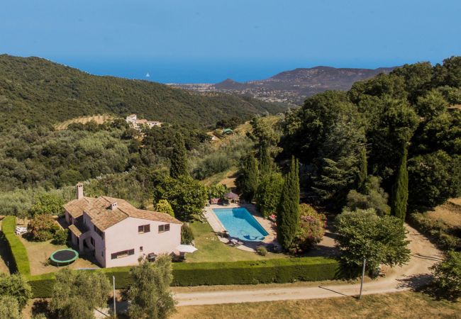 Aerial view of our holiday villa with pool and a view of the Bay of Cannes.