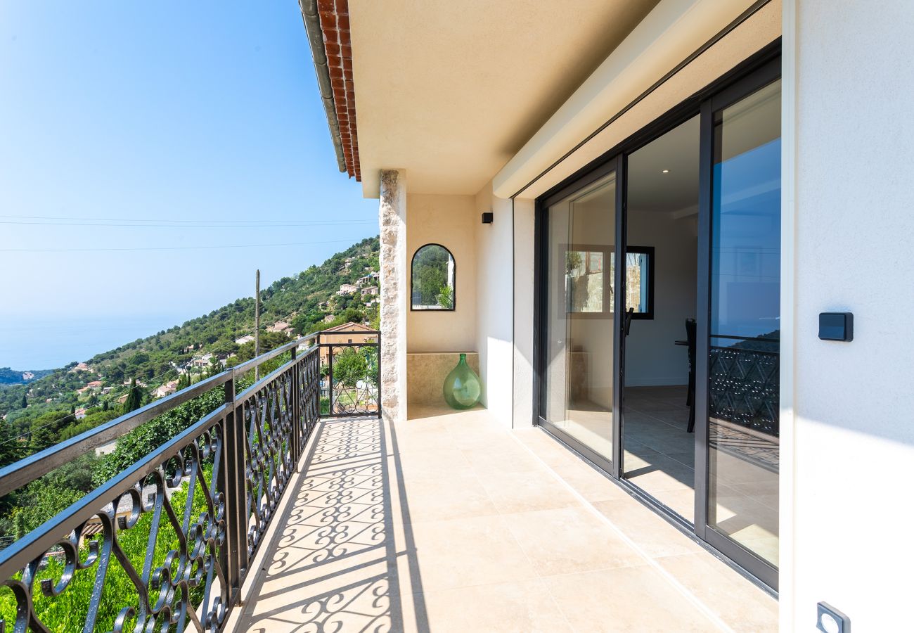 Sunny terrace with stunning sea and hill views, perfect for relaxing.